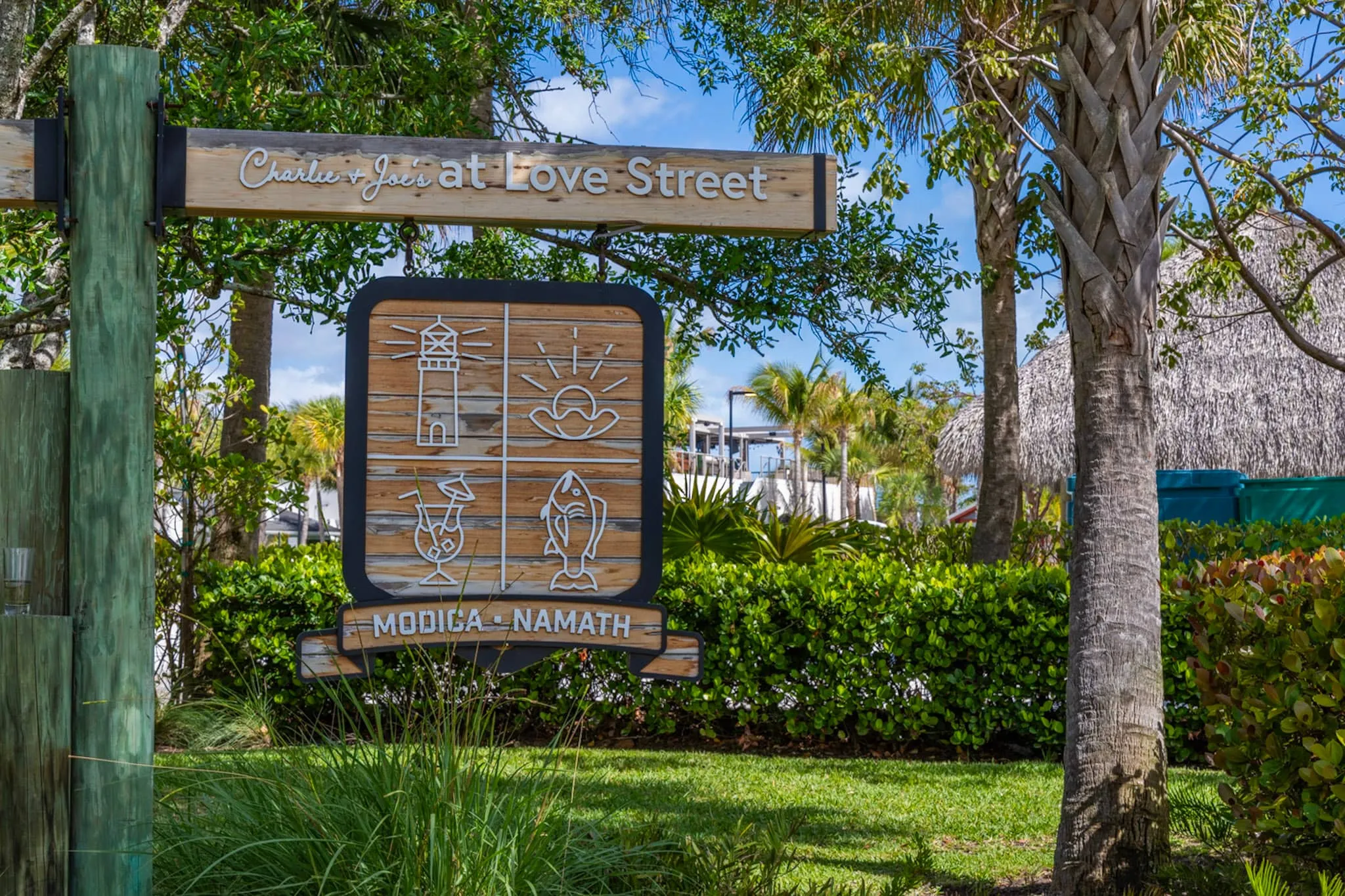 Carved entrance sign for Charlie + Joe's at Love Street in Jupiter, Florida