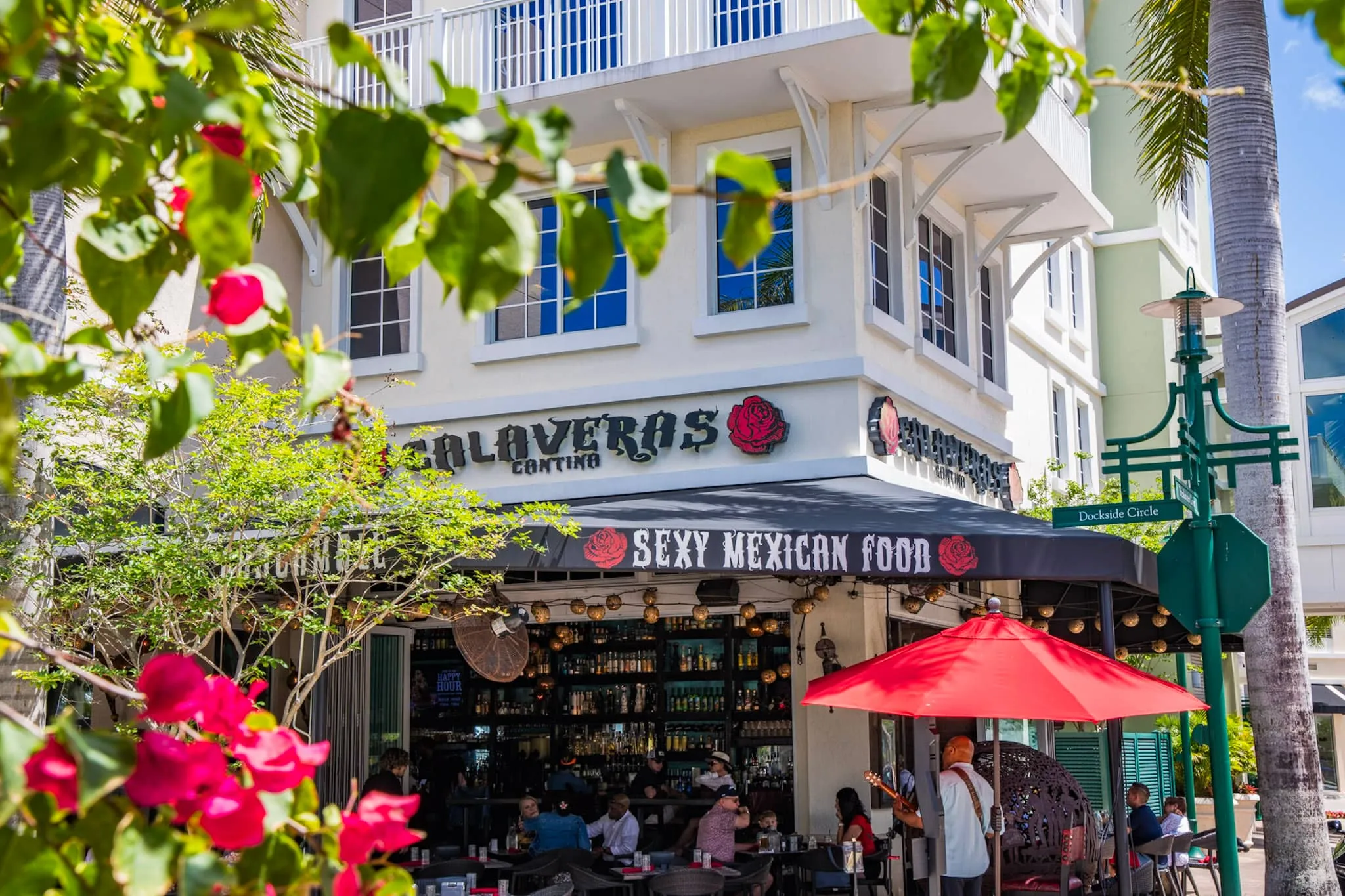 Calaveras Cantina on Dockside Circle at Harbourside Place in Jupiter, with sidewalk seating under a red umbrella