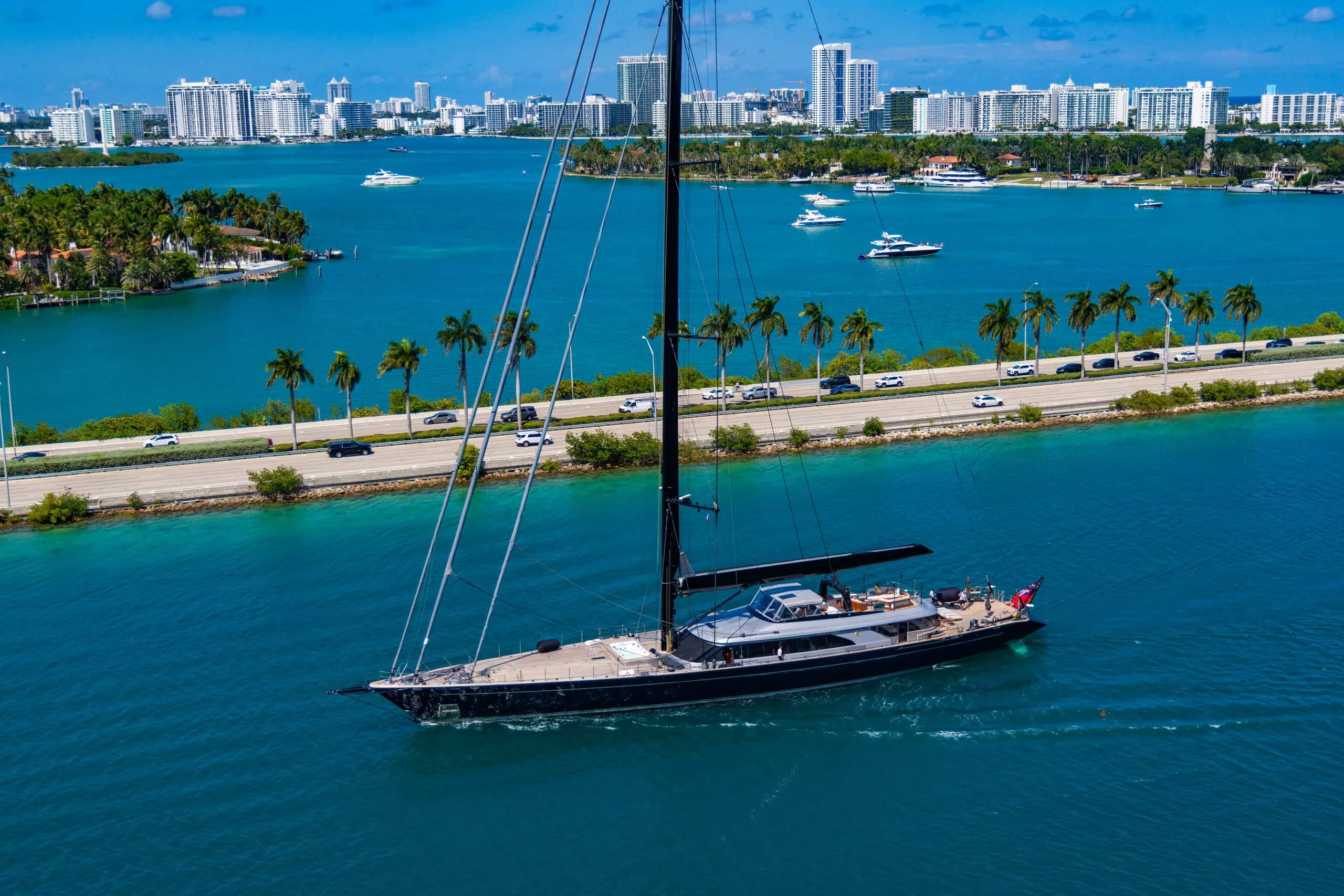 Aerial view of a sailing superyacht on turquoise water near Palm Beach County